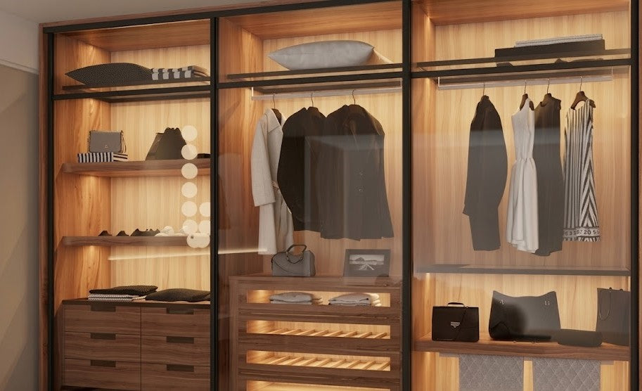Image of Modern wardrobe with wooden shelves, clothes, and accessories. Quba Symmetry Galaxy sliding Wooden wardrobe with sliding profile in a room.